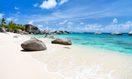 Beautiful tropical beach with white sand, turquoise ocean water and blue sky at Virgin Gorda, British Virgin Islands in Caribbean (Photo via shalamov / iStock / Getty Images Plus)