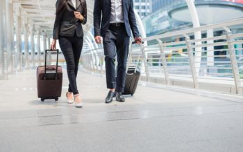 Travelers walking together with luggage