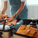 Woman packing a suitcase, suitcase, packing, packing for vacation, packing a suitcase