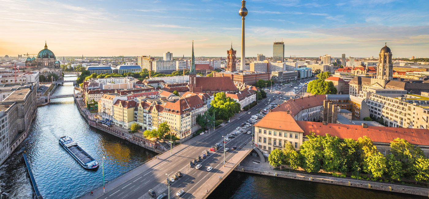 Image: Aerial view of Berlin skyline with famous TV tower and Spree river in beautiful evening light at sunset, Germany. (photo via bluejayphoto/iStock/Getty Images Plus)