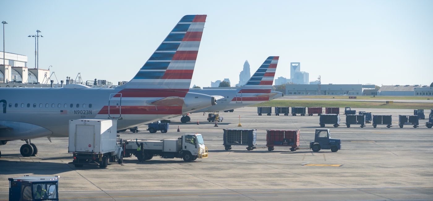 Image: American Airlines airplane at the gate of the Charlotte Douglas International Airport. (Photo Credit: Red Lemon / Adobe Stock)