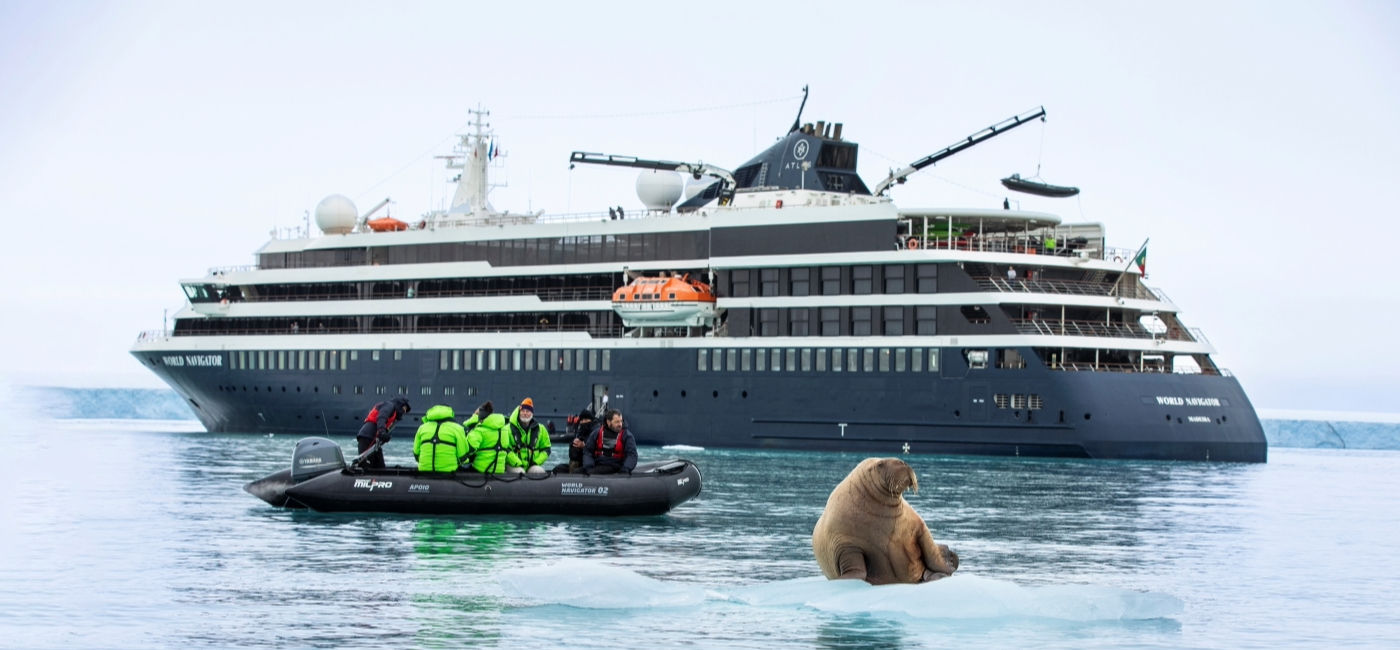 Image: An Atlas Ocean Voyages Zodiac expedition encounters a walrus on an iceberg in the Arctic. (Photo Credit: Atlas Ocean Voyages)