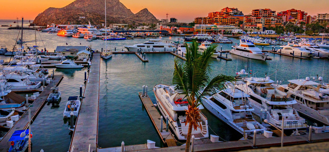 Image: Cabo San Lucas Marina at sunset. (Photo via LindaYG / iStock / Getty Images Plus)