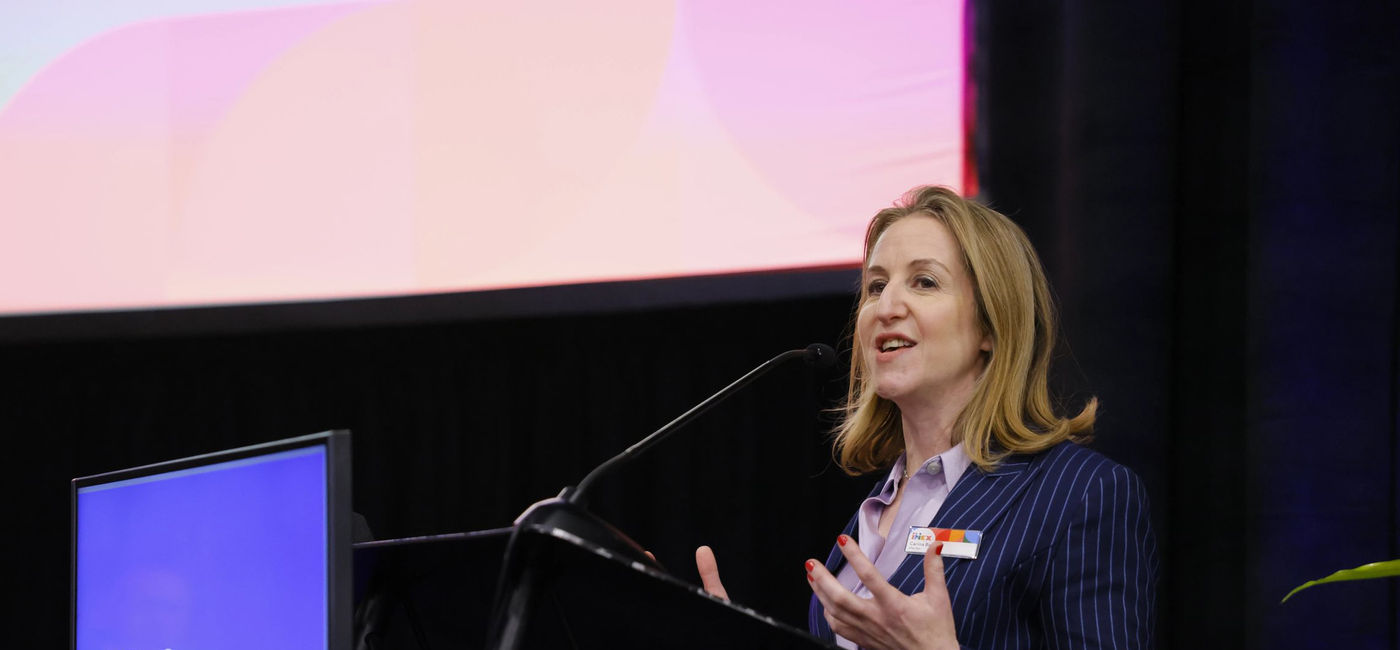 Image: Carina Bauer, IMEX CEO, speaks at the 2024 IMEX America show. (Photo Credit: IMEX America)