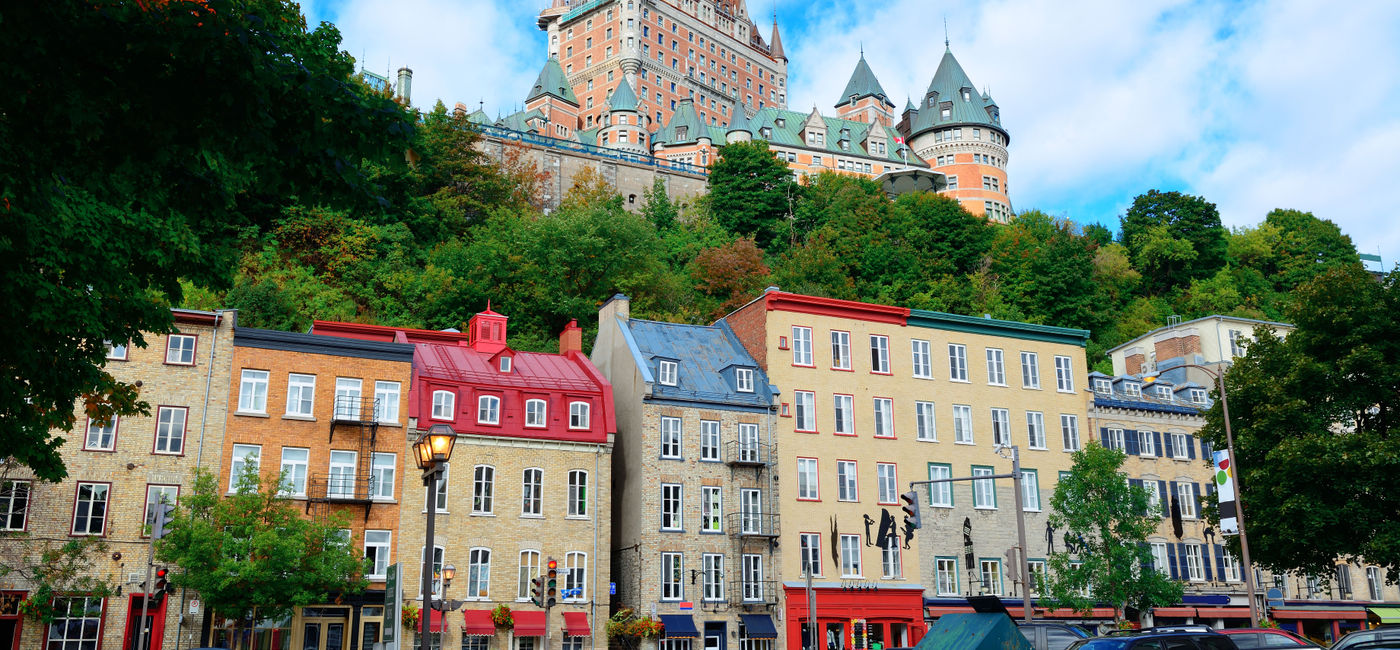 Image: Chateau Frontenac in the day with colorful buildings on street in Quebec City (Photo via rabbit75_ist / iStock / Getty Images Plus)