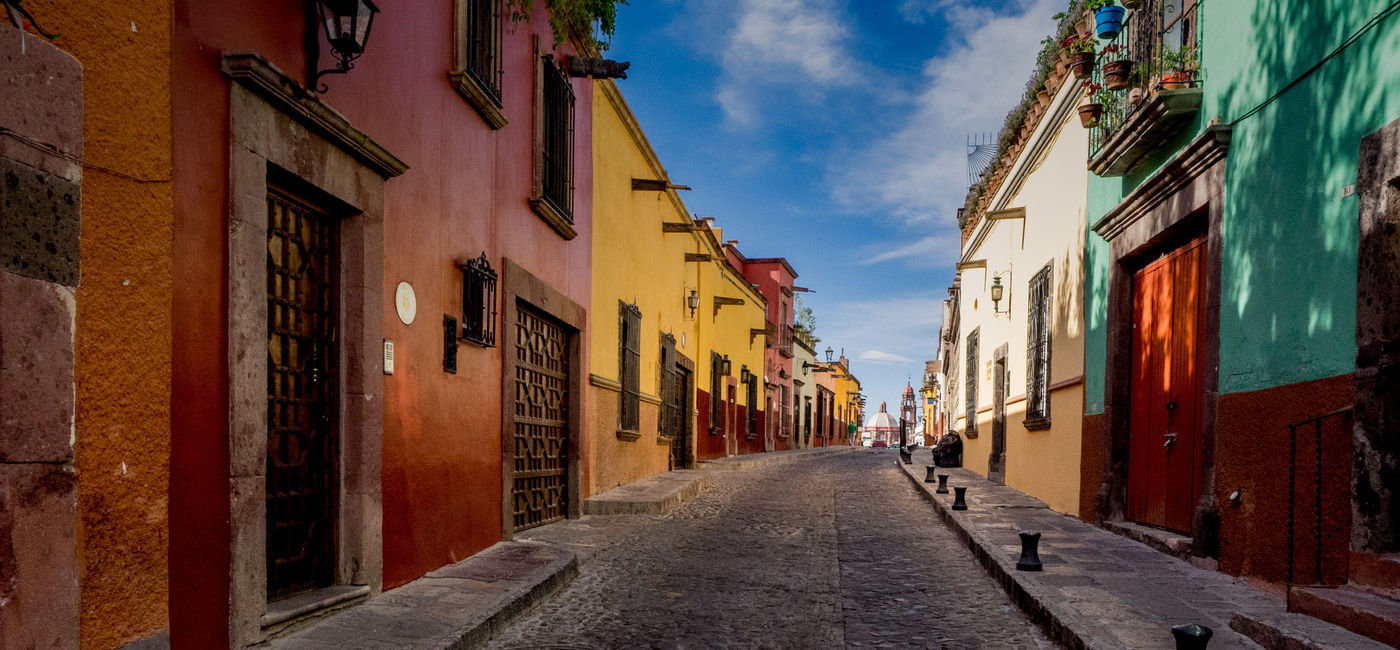 Image: The many backstreets of San Miguel de Allende in Mexico can be quiet, colorful and beautifully preserved. A wonderful serene place for a morning or evening walk. (photo via thupton / iStock / Getty Images Plus)