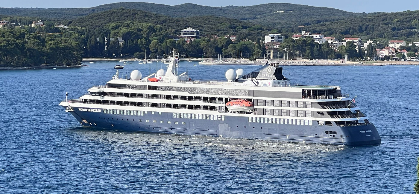 Image: The World Traveller ship as seen from Rovinj, Croatia. (Photo Credit: Photo by Paul J. Heney.)