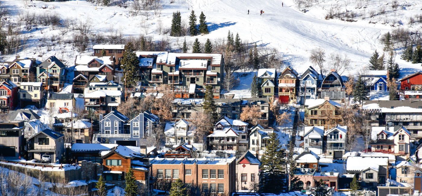 Image: Vacation homes and hotels lay under ski hills in Park City, Utah. (Photo Credit: Ryan Tishken / AdobeStock)