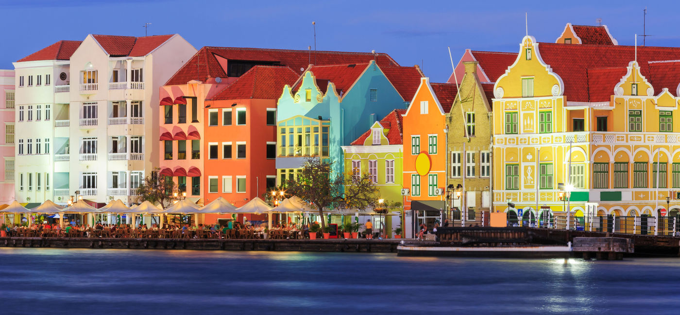 Image: View of downtown Willemstad at twilight. Curacao, Netherlands Antilles (Photo via sorincolac / iStock / Getty Images Plus)