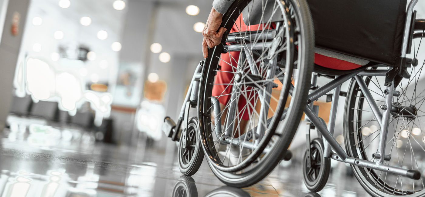 Image: Wheelchair user at the airport. (Photo Credit: Adobe Stock/Yakobchuk Olena)