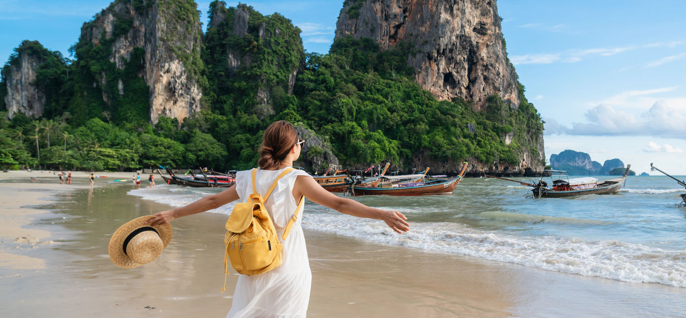 Image: Young female traveler enjoying a summer vacation on a tropical beach in Krabi, Thailand. (Photo Credit: Adobe Stock/Kittiphan)