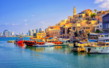 Old town and port of Jaffa and modern skyline of Tel Aviv city, Israel (photo via Xantana / iStock / Getty Images Plus)