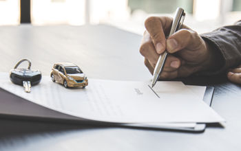 Traveler signing a rental car agreement