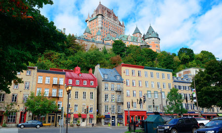 Chateau Frontenac in the day with colorful buildings on street in Quebec City (Photo via rabbit75_ist / iStock / Getty Images Plus)