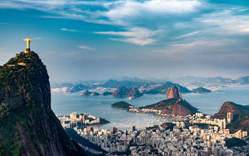 Aerial view of Rio De Janeiro. Corcovado mountain with statue of Christ the Redeemer, urban areas of Botafogo, Flamengo and Centro, Sugarloaf mountain. (photo via microgen / iStock / Getty Images Plus)